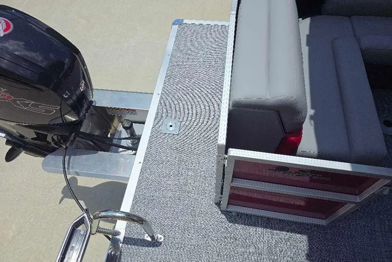 Slide: The Image of 2026 Sun Tracker Party Barge 20 DLX with motor and seating area, top view. - 14