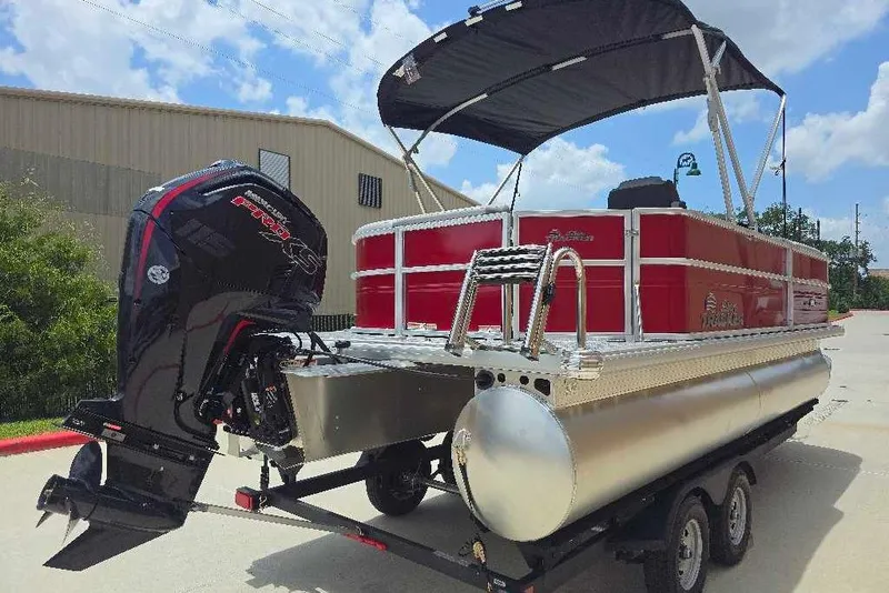 Slide: The Image of 2026 Sun Tracker Party Barge 20 DLX pontoon boat with outboard motor on trailer. - 4