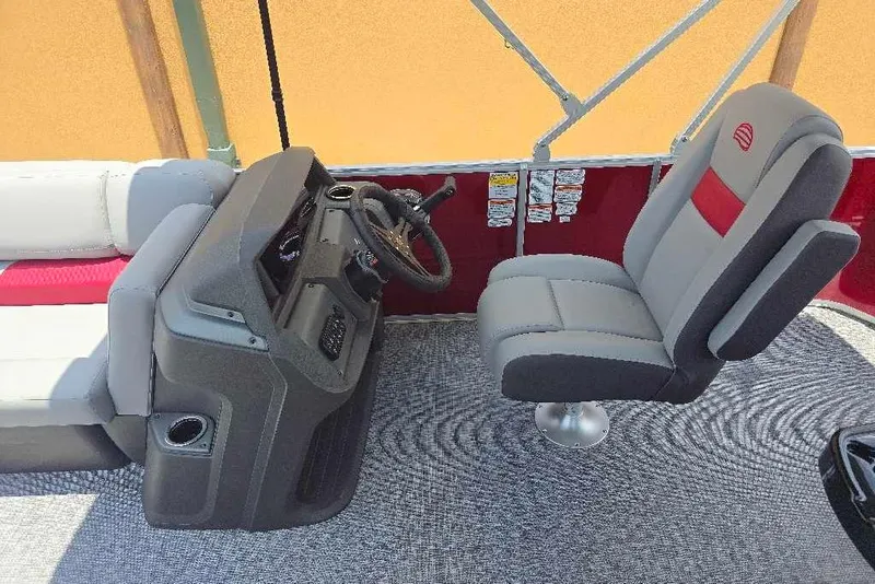 Slide: The Image of 2026 Sun Tracker Party Barge 20 DLX interior with captain's chair and helm. - 11