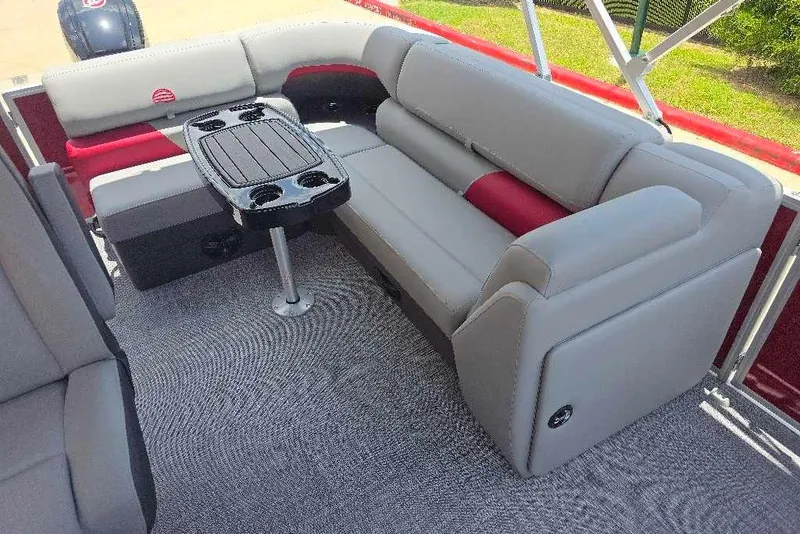Slide: The Image of 2026 Sun Tracker Party Barge 20 DLX interior with plush seating and central table. - 12