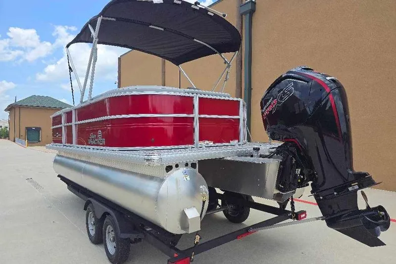 Slide: The Image of 2026 Sun Tracker Party Barge 20 DLX pontoon boat with outboard motor on trailer. - 5