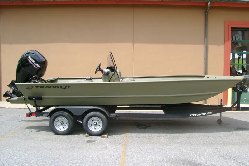 The Image of 2026 Tracker Grizzly 2072 CC boat on trailer, featuring a Mercury outboard motor. - 0
