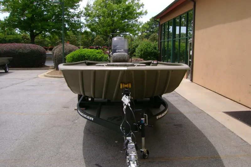 Slide: The Image of 2026 Tracker Grizzly 2072 CC boat on trailer, parked outdoors near a building. - 3