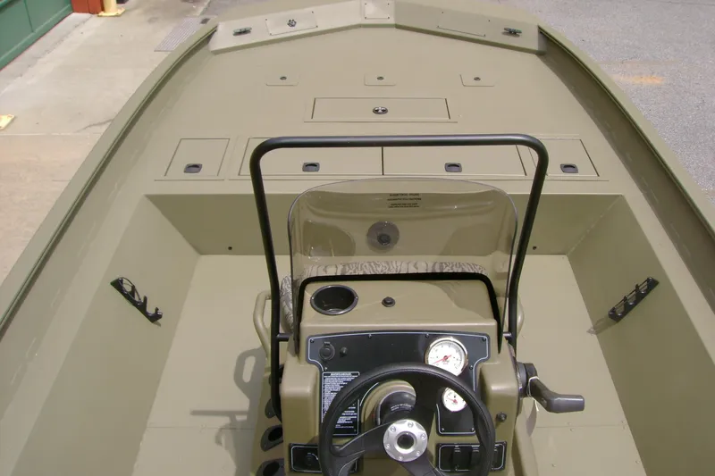Slide: The Image of 2026 Tracker Grizzly 2072 CC boat interior with steering console and storage compartments. - 6
