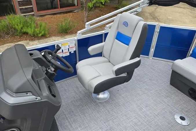Slide: The Image of 2026 Sun Tracker Party Barge 20 DLX interior with captain's chair and steering console. - 9
