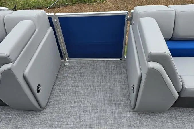 Slide: The Image of 2026 Sun Tracker Party Barge 20 DLX interior with gray seating and blue gate. - 11