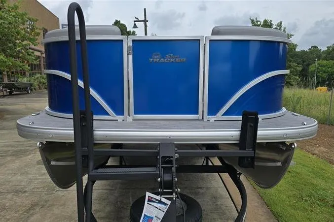 Slide: The Image of 2026 Sun Tracker Party Barge 20 DLX pontoon boat with blue exterior on trailer. - 6