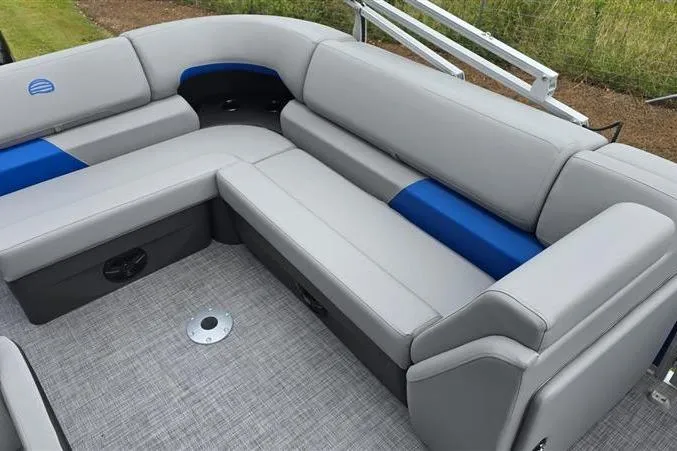 Slide: The Image of 2026 Sun Tracker Party Barge 20 DLX interior with gray and blue seating, spacious layout. - 10