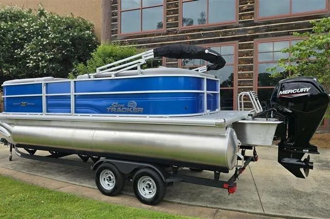 Slide: The Image of 2026 Sun Tracker Party Barge 20 DLX pontoon boat with Mercury engine on trailer. - 3