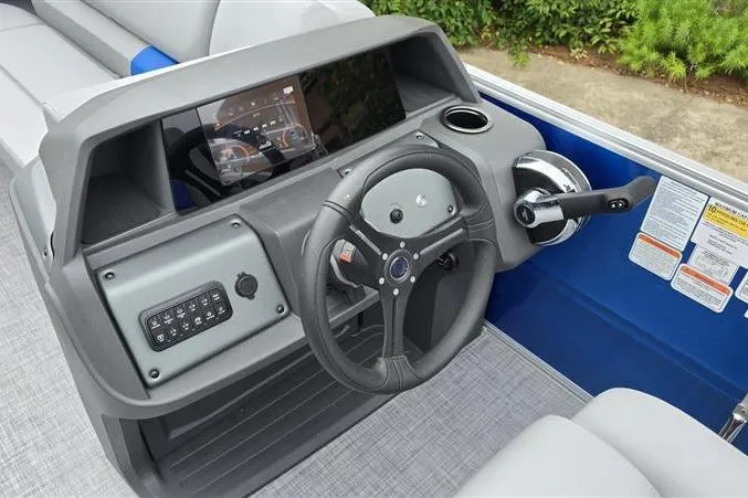 Slide: The Image of 2026 Sun Tracker Party Barge 20 DLX dashboard with steering wheel and control panel. - 13