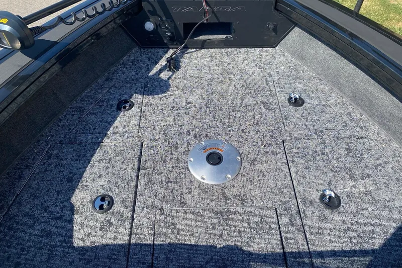 Slide: The Image of 2026 Tracker Targa V-19 Combo boat deck with textured flooring and mounting points. - 6