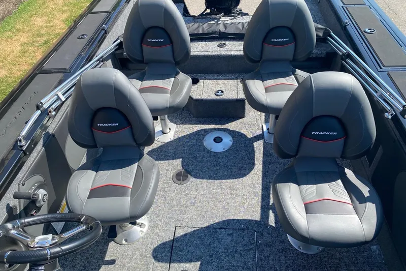 Slide: The Image of 2026 Tracker Targa V-19 Combo boat interior with four gray seats and steering wheel. - 3