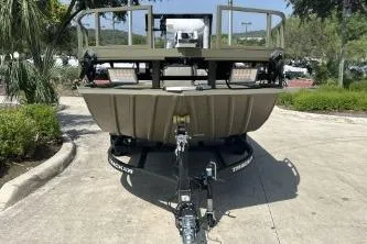 The Image of 2026 Tracker Grizzly 2072 CC Sportsman boat on trailer, parked outdoors. - 0