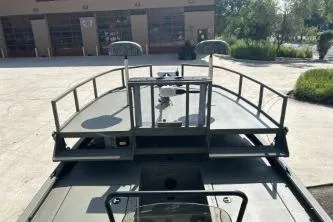 Slide: The Image of 2026 Tracker Grizzly 2072 CC Sportsman boat with elevated deck and railing. - 5