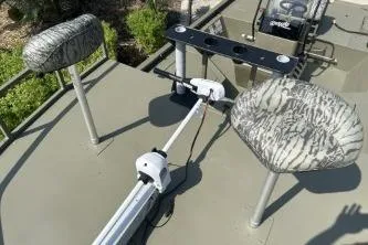 Slide: The Image of 2026 Tracker Grizzly 2072 CC Sportsman boat interior with camo seats and trolling motor. - 7