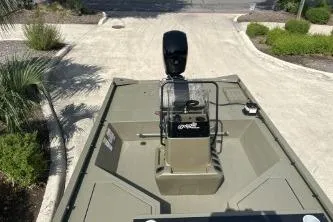 Slide: The Image of 2026 Tracker Grizzly 2072 CC Sportsman boat on a paved driveway, surrounded by greenery. - 6