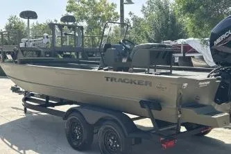Slide: The Image of 2026 Tracker Grizzly 2072 CC Sportsman boat on trailer, outdoors. - 3