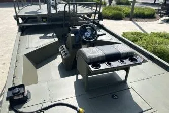 Slide: The Image of 2026 Tracker Grizzly 2072 CC Sportsman boat interior with steering console and seating. - 4