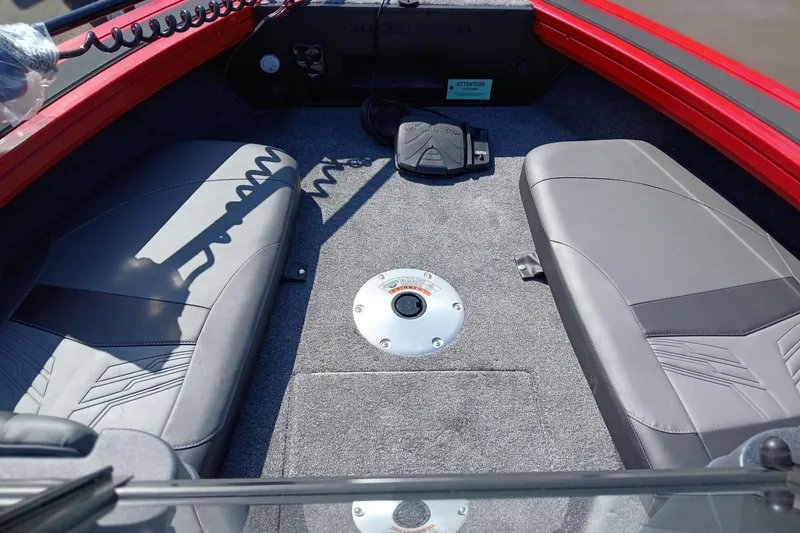 Slide: The Image of Interior of 2026 Tracker Targa V-18 WT boat with gray seating and carpeted floor. - 2