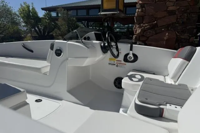 Slide: The Image of 2026 Tahoe T16 boat interior with steering wheel and seating, showcasing modern design. - 9