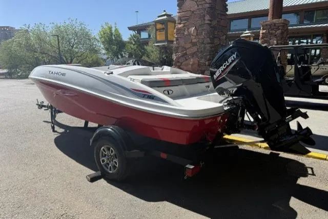 Slide: The Image of 2026 Tahoe T16 boat with Mercury engine on trailer, parked outdoors. - 2