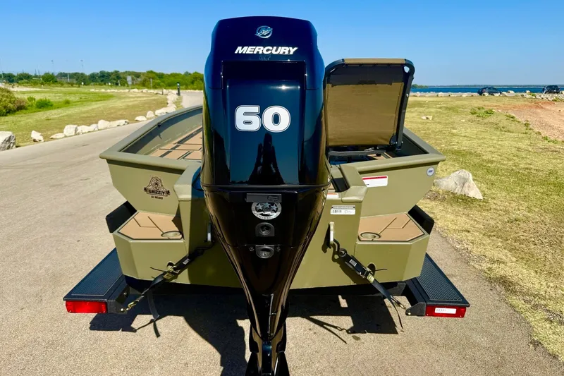 Slide: The Image of 2026 Tracker Grizzly 1756 T Marsh boat with Mercury 60 engine on a sunny day. - 21
