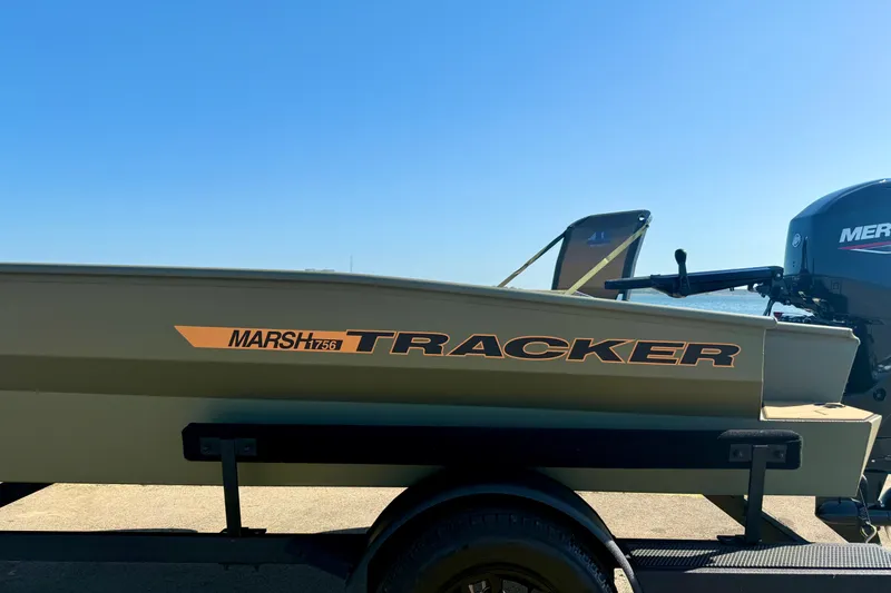 Slide: The Image of 2026 Tracker Grizzly 1756 T Marsh boat on trailer, sunny day background. - 14