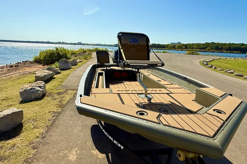 Slide: The Image of 2026 Tracker Grizzly 1756 T Marsh boat on a lakeside path under clear blue skies. - 15