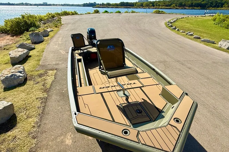 Slide: The Image of 2026 Tracker Grizzly 1756 T Marsh boat on a lakeside ramp, ready for launch. - 16