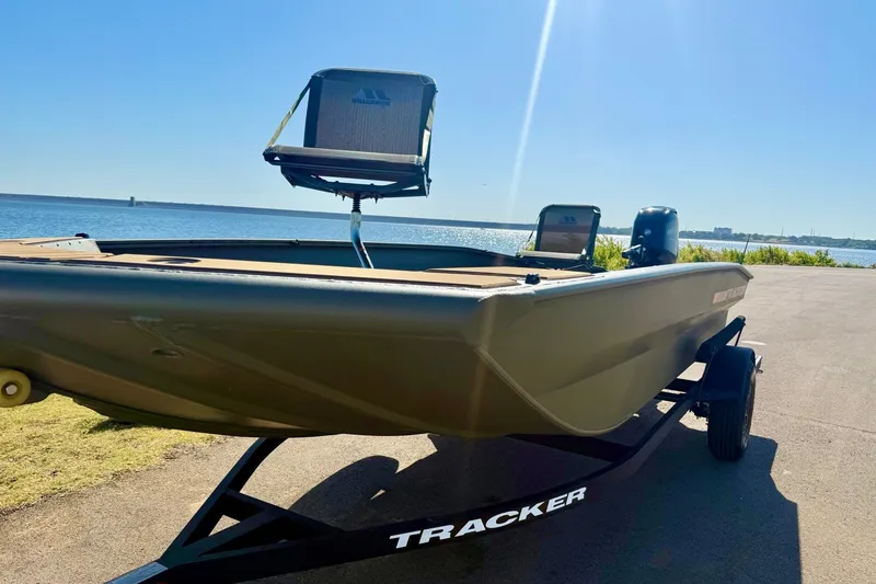 Slide: The Image of 2026 Tracker Grizzly 1756 T Marsh boat on trailer by the water. - 19