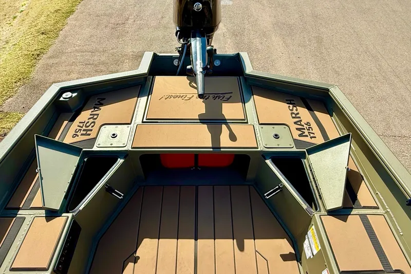 Slide: The Image of 2026 Tracker Grizzly 1756 T Marsh boat interior with open storage compartments. - 18