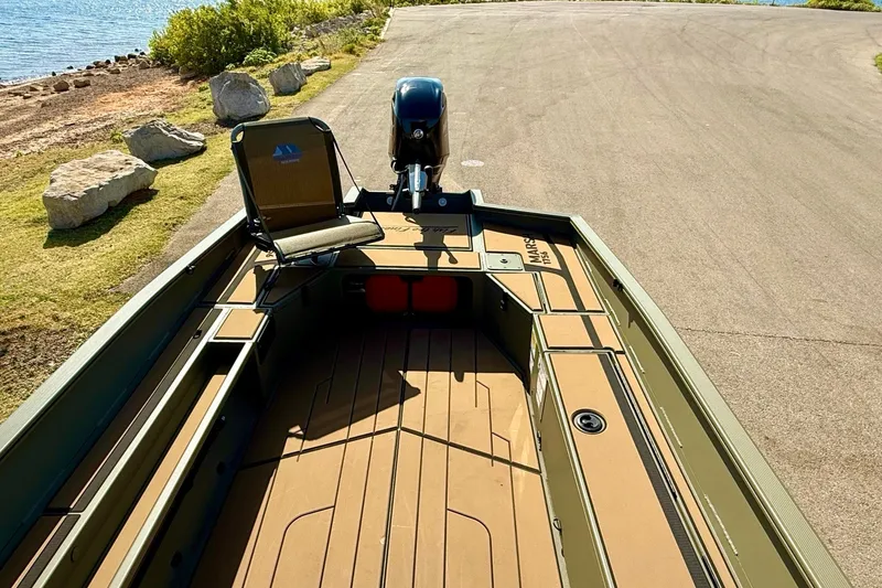 Slide: The Image of 2026 Tracker Grizzly 1756 T Marsh boat on a sunny lakeside ramp. - 17