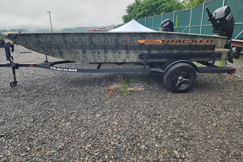 The Image of 2026 Tracker Grizzly 1756 T Marsh boat on trailer, parked on gravel. - 0