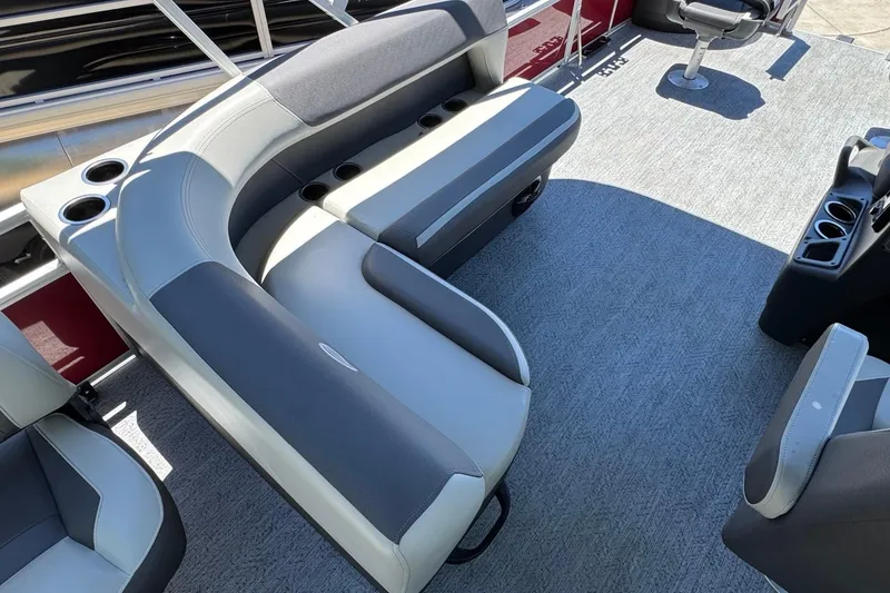 Slide: The Image of 2026 Sun Tracker Fishin' Barge 20 DLX interior with comfortable seating and cup holders. - 7