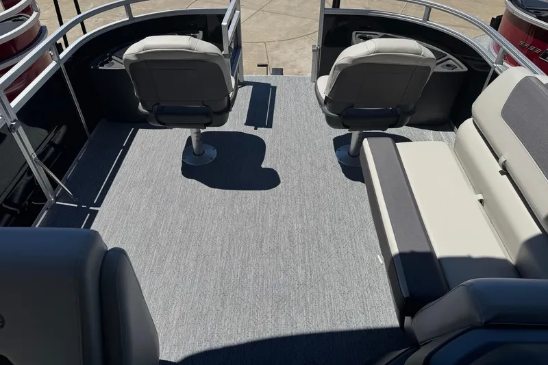 Slide: The Image of 2026 Sun Tracker Fishin' Barge 20 DLX interior with seating and railing. - 13