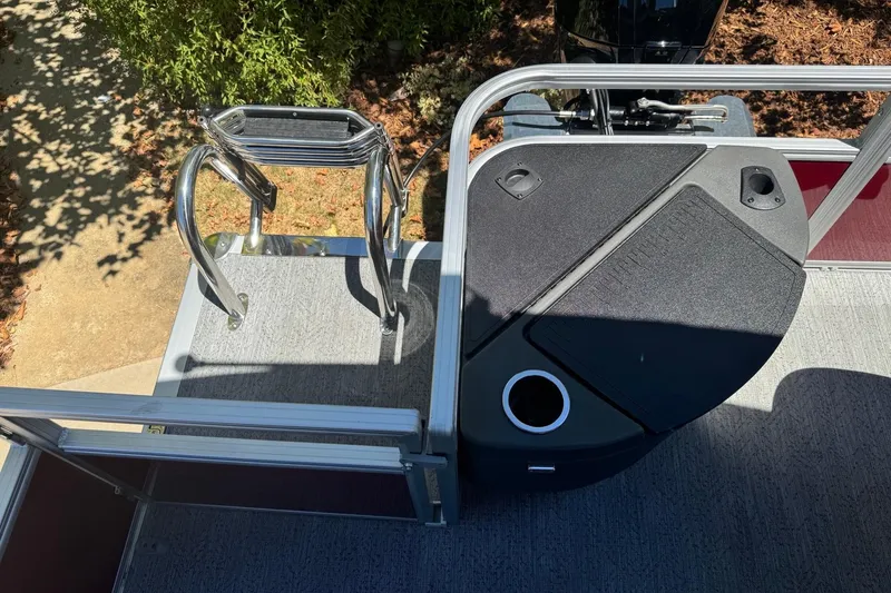 Slide: The Image of 2026 Sun Tracker Fishin' Barge 20 DLX deck with ladder and storage compartments. - 15