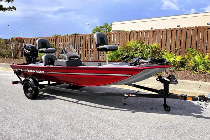 Slide: The Image of 2026 Tracker Bass Tracker Classic XL boat on trailer, red exterior, parked outdoors. - 4