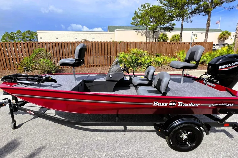 Slide: The Image of 2026 Tracker Bass Tracker Classic XL boat, red exterior, parked outdoors on a sunny day. - 10