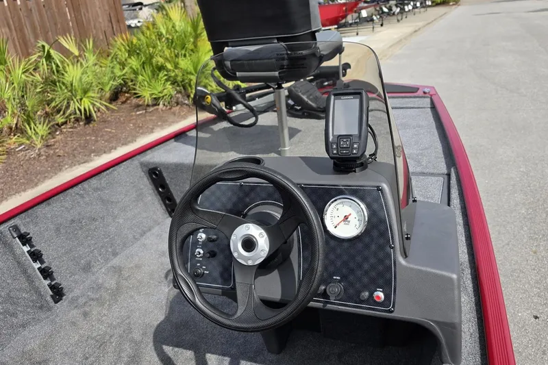 Slide: The Image of 2026 Tracker Bass Tracker Classic XL boat dashboard with steering wheel and navigation system. - 11