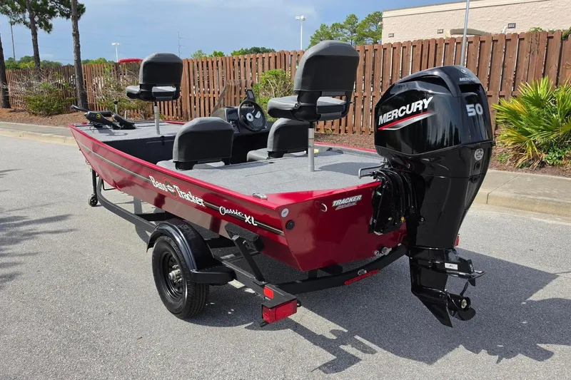 Slide: The Image of 2026 Tracker Bass Tracker Classic XL boat with Mercury 50 engine, parked outdoors. - 9
