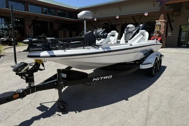 The Image of 2026 Nitro Z19 XL Pro boat on trailer, parked outside a building. - 0