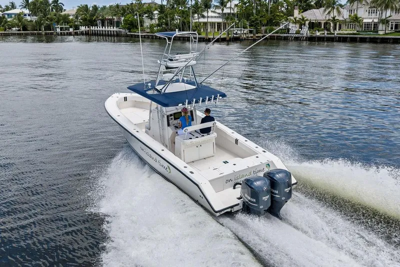 Slide: The Image of 1997 Venture 34 Center Console boat cruising on a scenic waterway. - 10