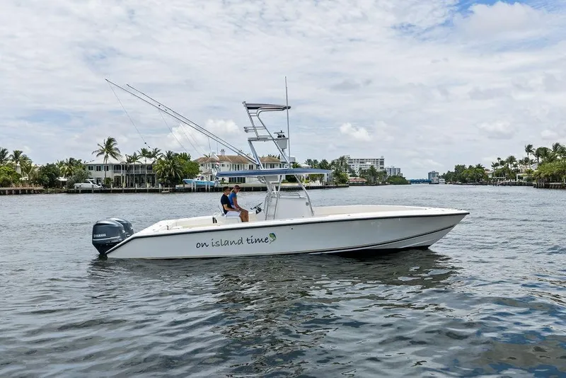 Slide: The Image of 1997 Venture 34 Center Console boat on water, labeled "on island time," with palm trees in background. - 18