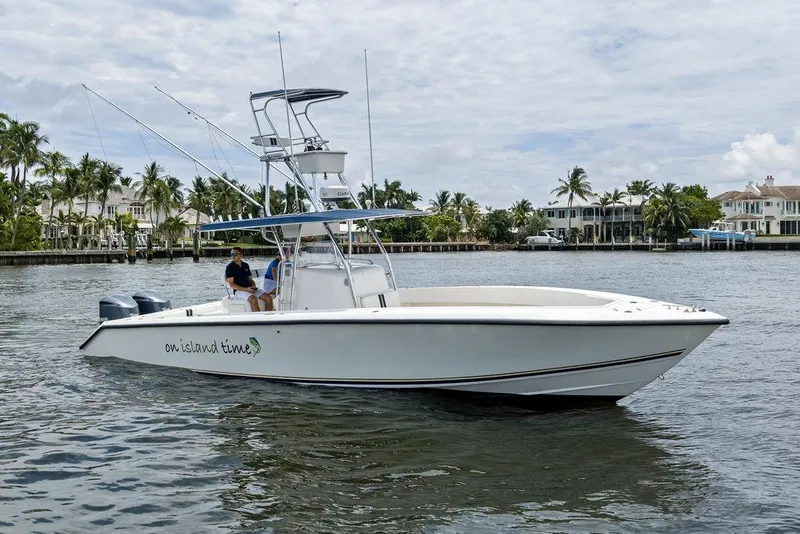 Slide: The Image of 1997 Venture 34 Center Console boat on water, palm trees and houses in background. - 19