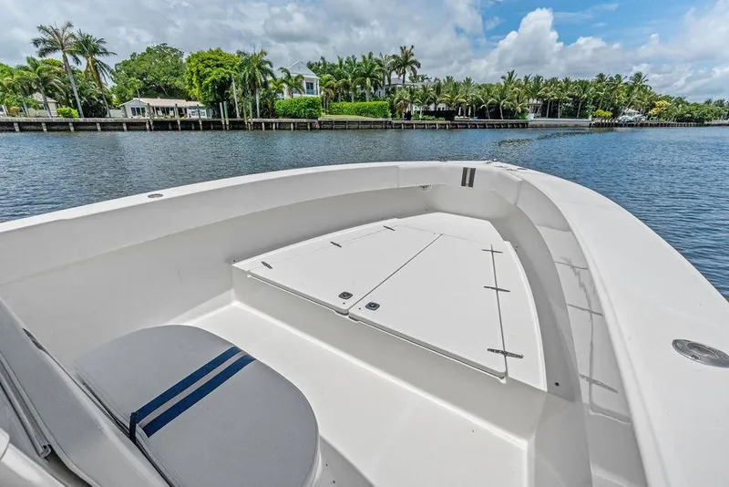 Slide: The Image of 1997 Venture 34 Center Console boat on a serene waterway with lush greenery. - 20