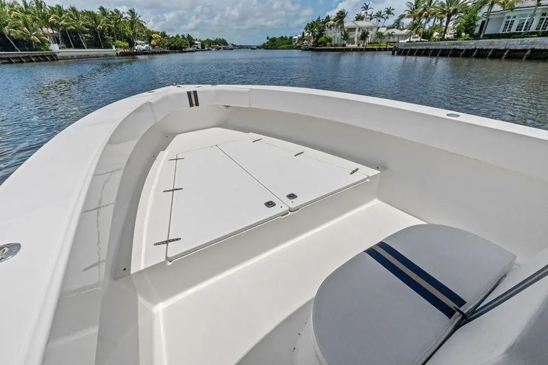 Slide: The Image of 1997 Venture 34 Center Console boat on a scenic waterway with palm trees. - 21