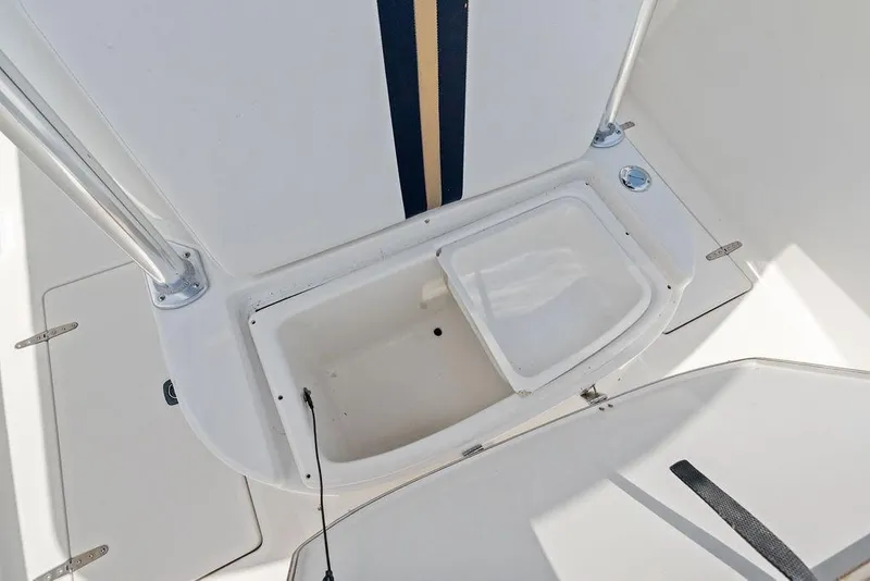 Slide: The Image of 1997 Venture 34 Center Console boat storage compartment with open hatch. - 24