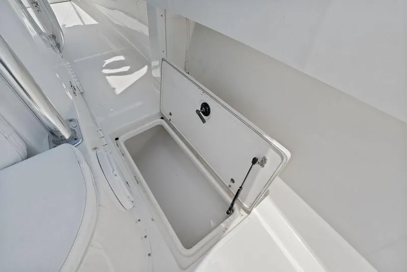 Slide: The Image of Open storage compartment on 1997 Venture 34 Center Console boat deck. - 26