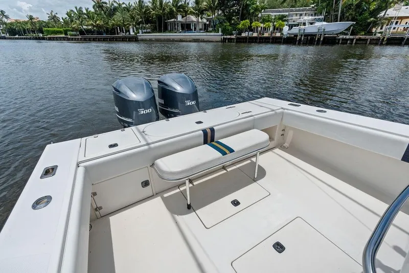 Slide: The Image of 1997 Venture 34 Center Console boat with dual Yamaha 300 engines on a calm waterway. - 27
