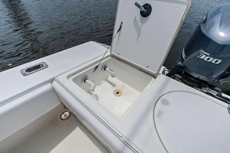 Slide: The Image of 1997 Venture 34 Center Console boat with open hatch and Yamaha 300 engine. - 28